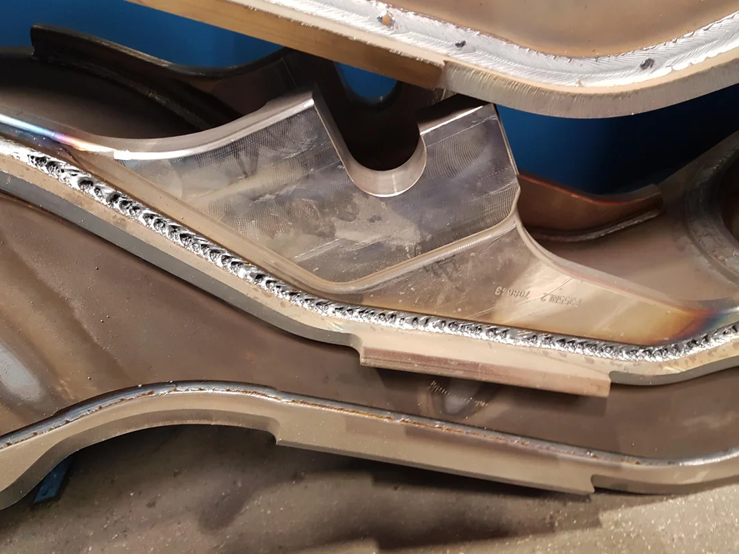 Long continuous weld seam along a shaped steel component