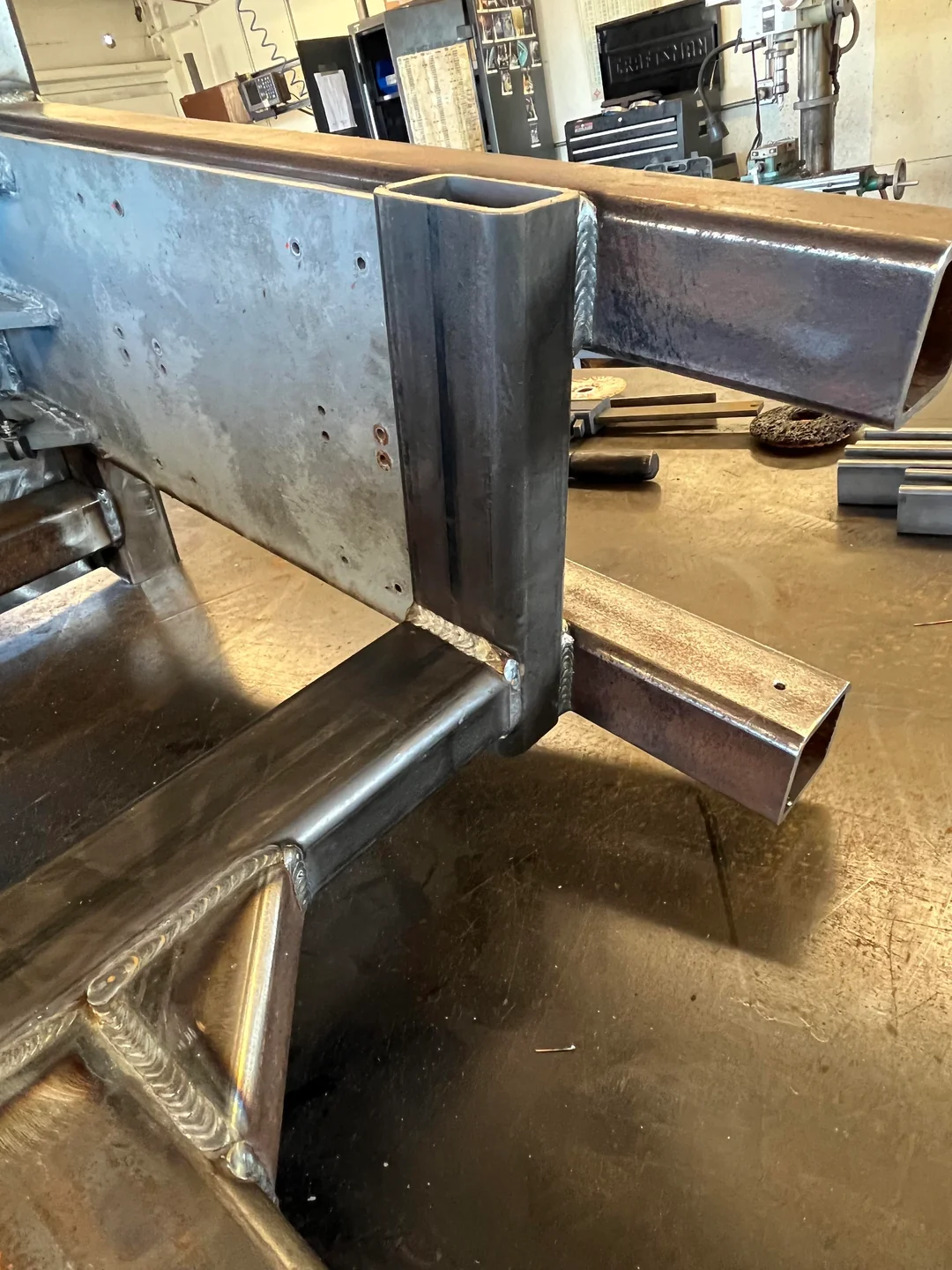 Welded steel frame assembly in a workshop